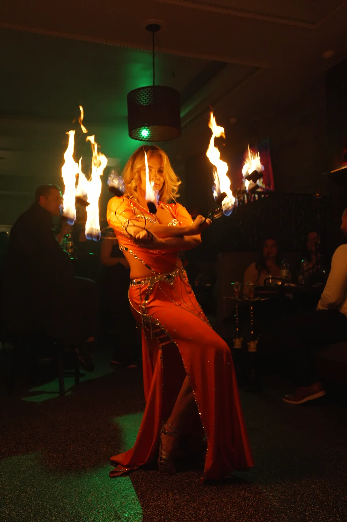 A performer with flaming fans during an evening at Classic Café & Lounge